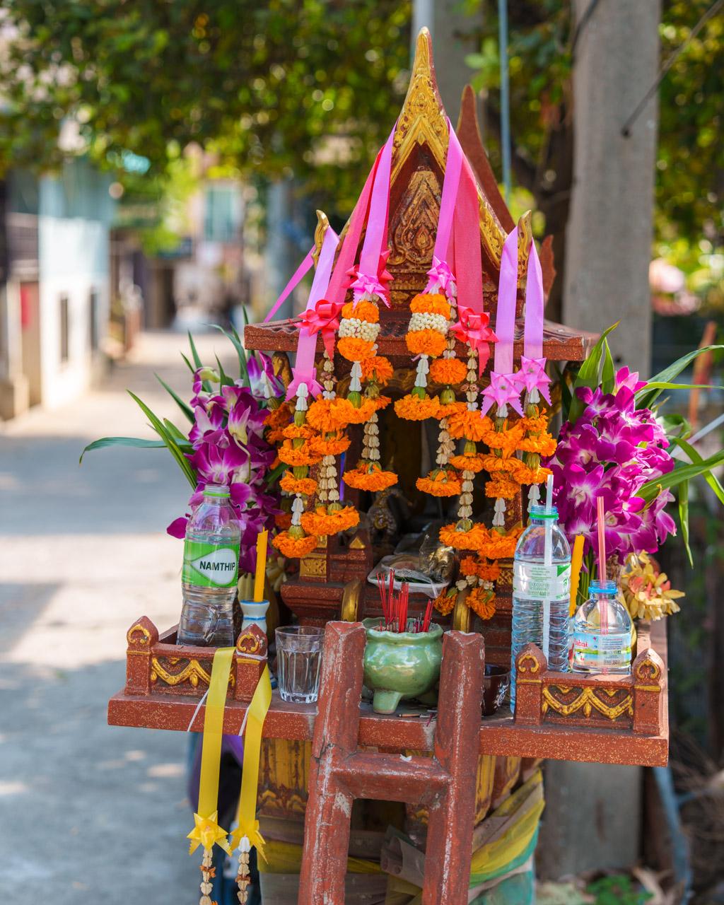 Colourful spirit house in Ayutthaya on quiet street