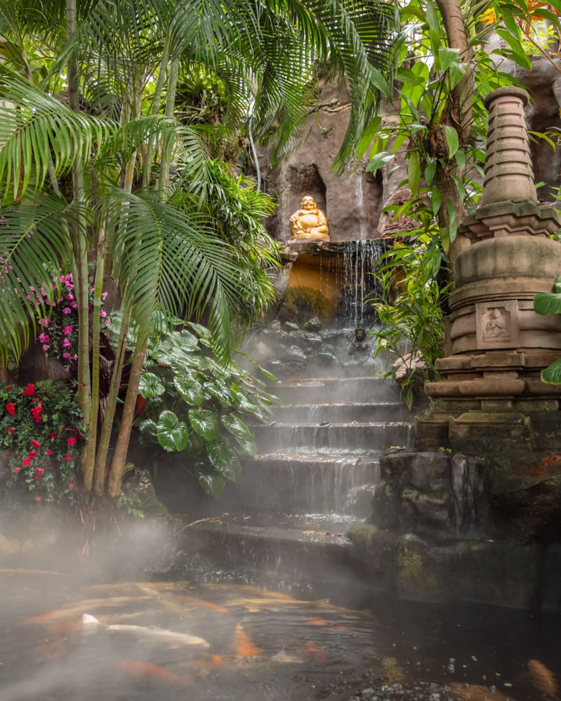 Small pond and Buddha statue on the way up the Golden Mount