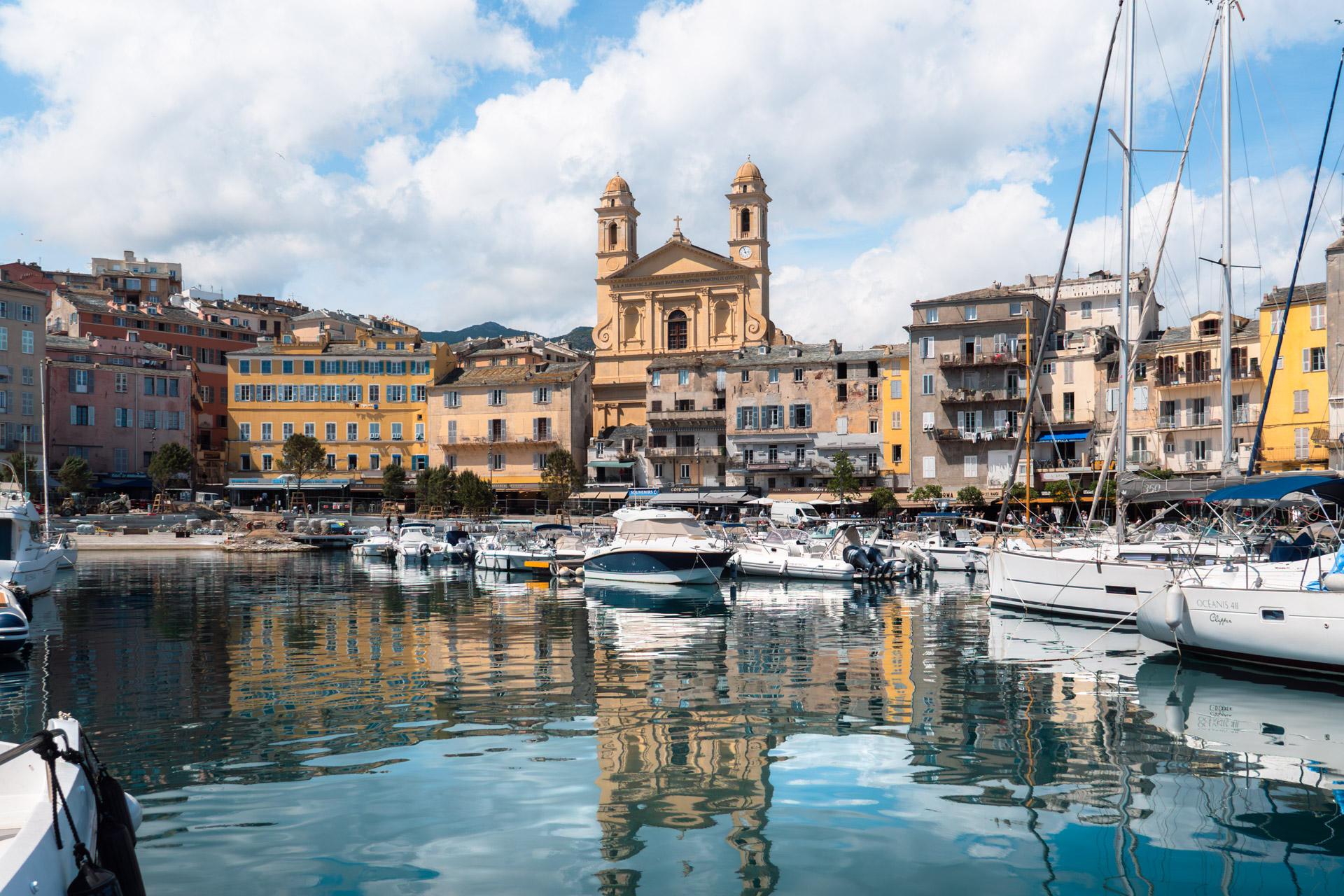 Twin bell towers of Église Saint-Jean-Baptiste rising above Bastia's old harbour.