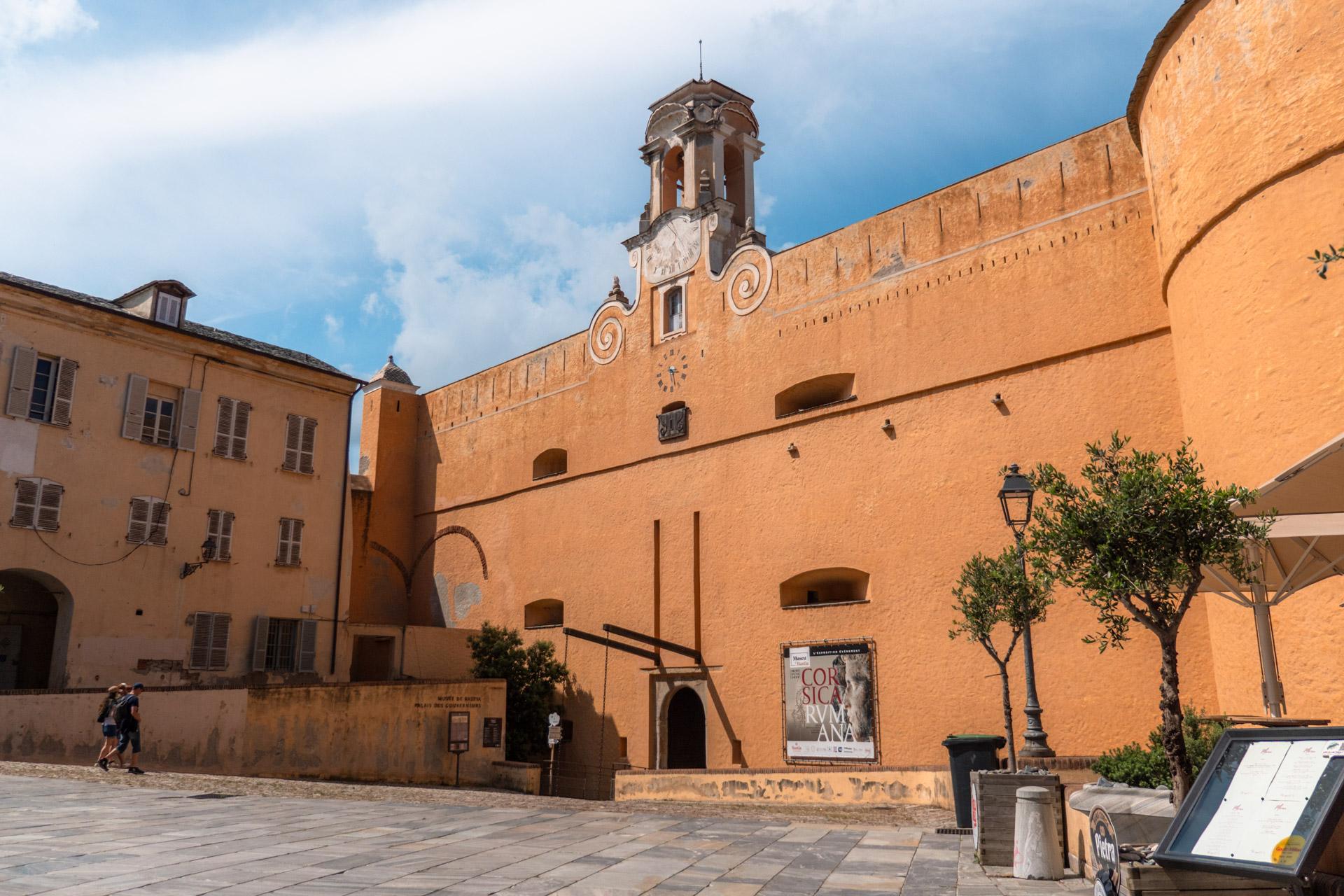 Exterior of the Palace of the Governors in Bastia's citadel with ochre-coloured walls.