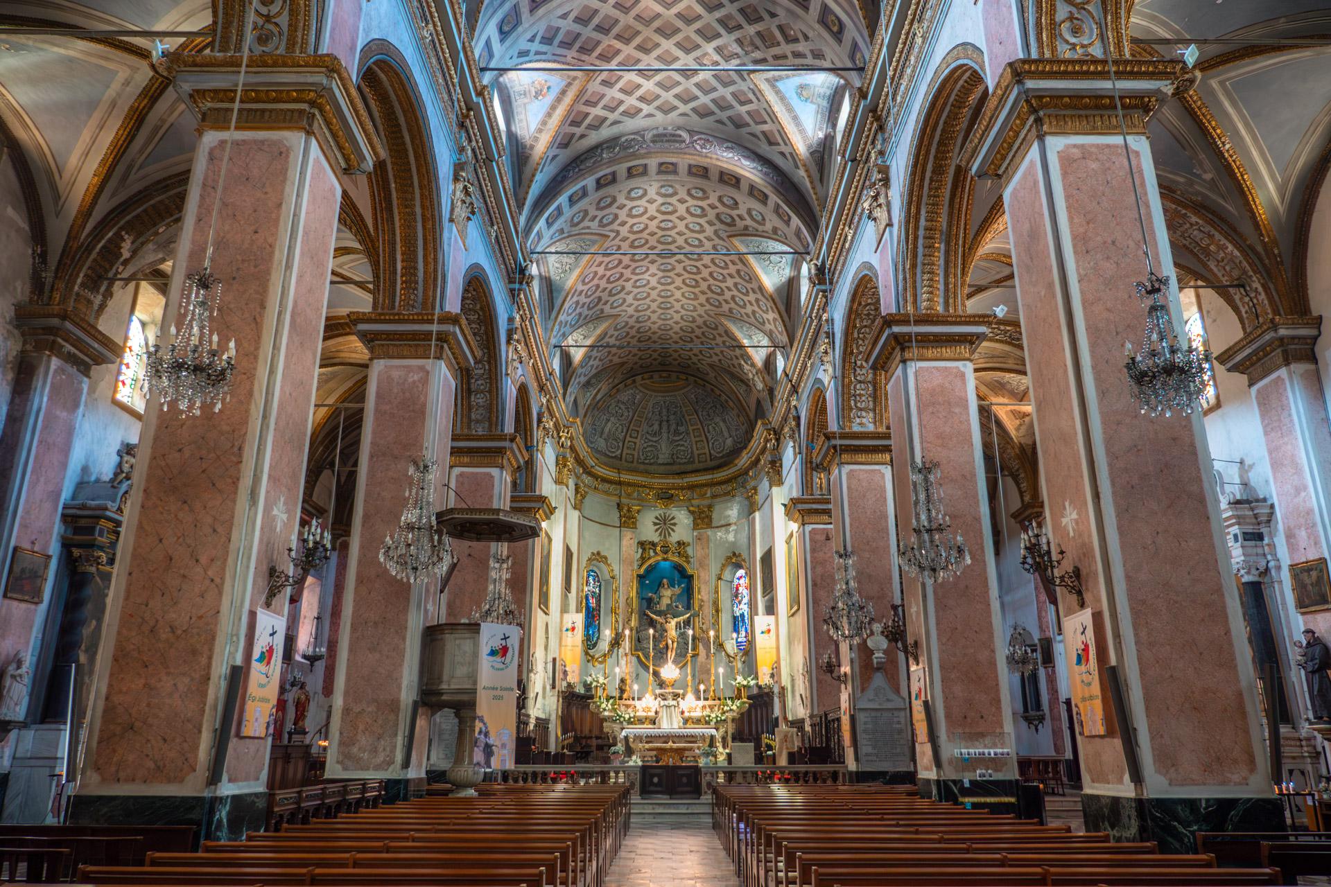Interior of Bastia Cathedral with decorated altar, marble columns and gold accents.