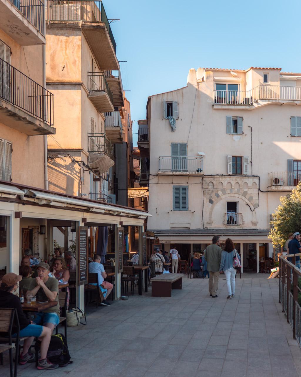 Small square with café in Bonifacio's old town at sunset