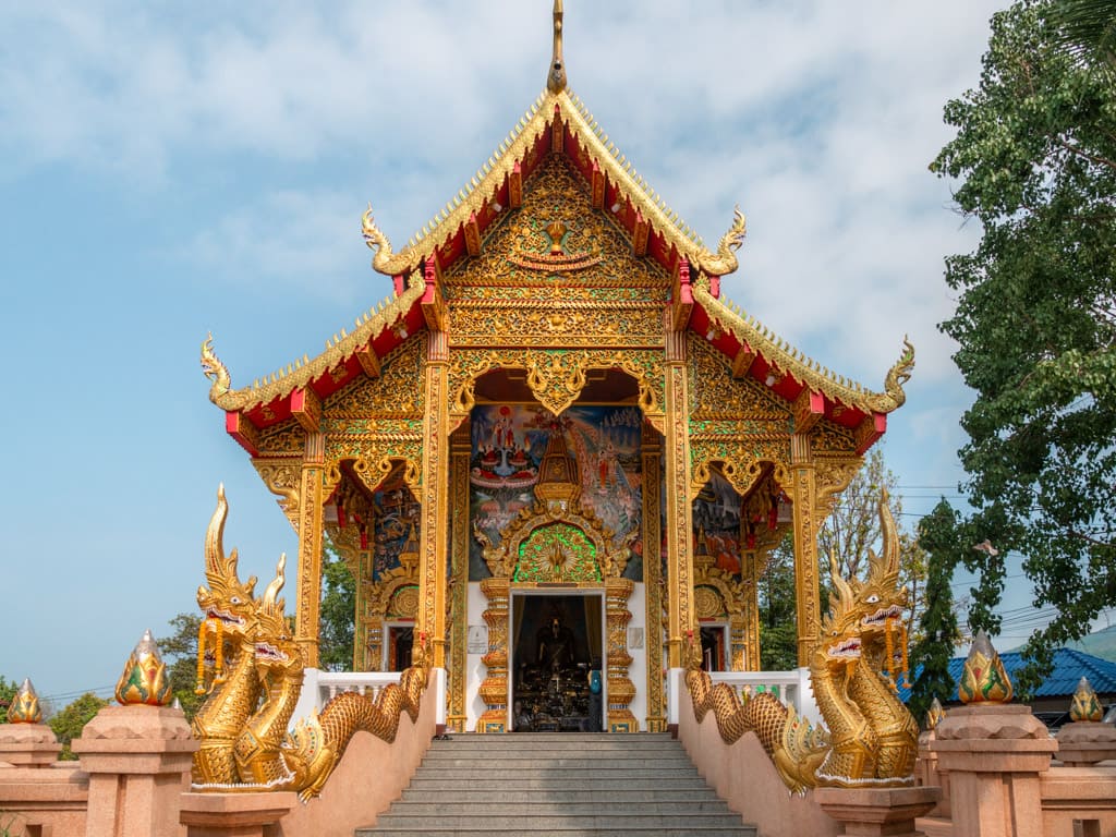 Wat Phra That Doi Kham temple with paintings above the entrance