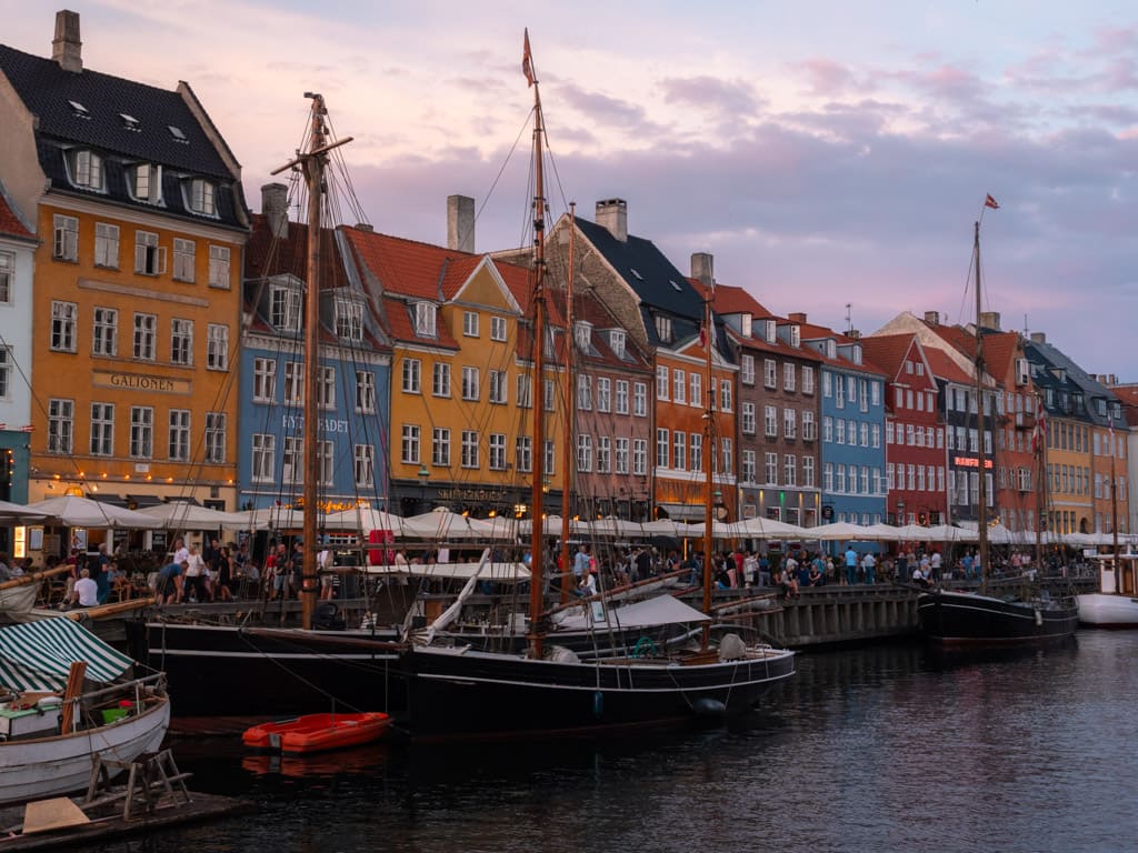 Old houses and the historical wooden ships in the canal in Nyhavn