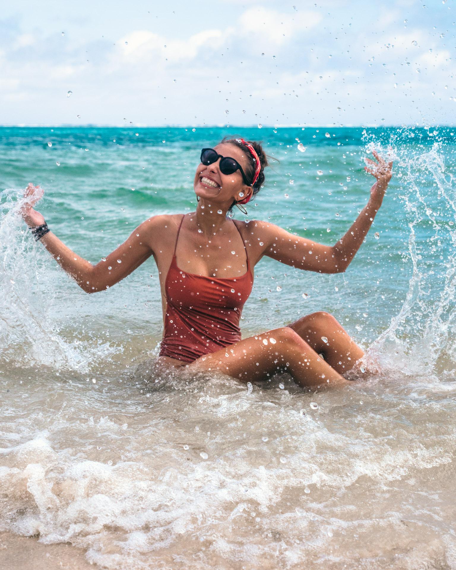 Victoria splashing in turquoise waters, looking happy