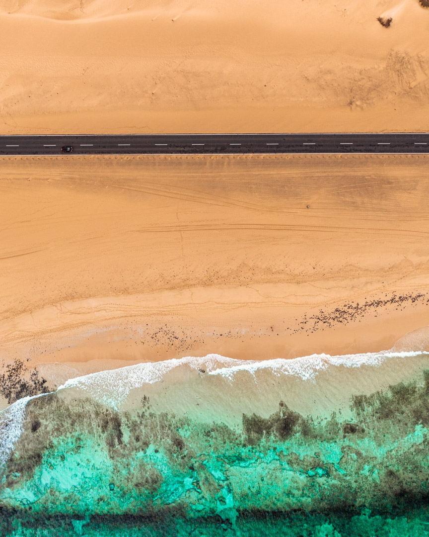 Drone shot of the beach and the road at Corralejo natural park