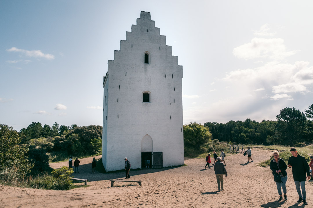 People visiting the Sand-Covered Church in Skagen, Denmark