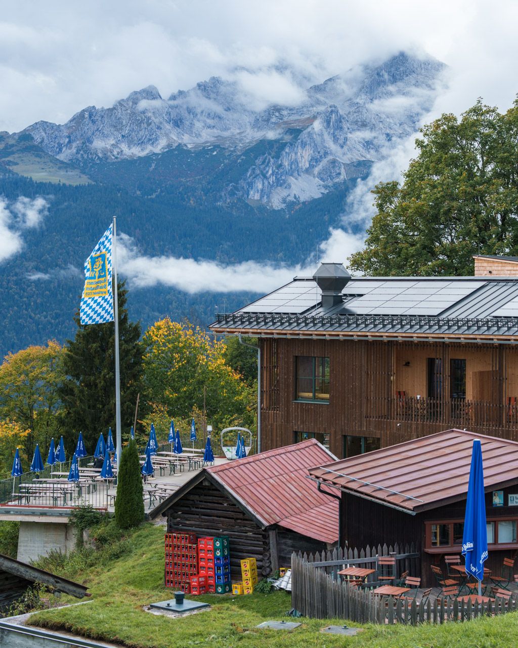 Hut with terrace near the Eckbauer top station with Wetterstein peaks behind