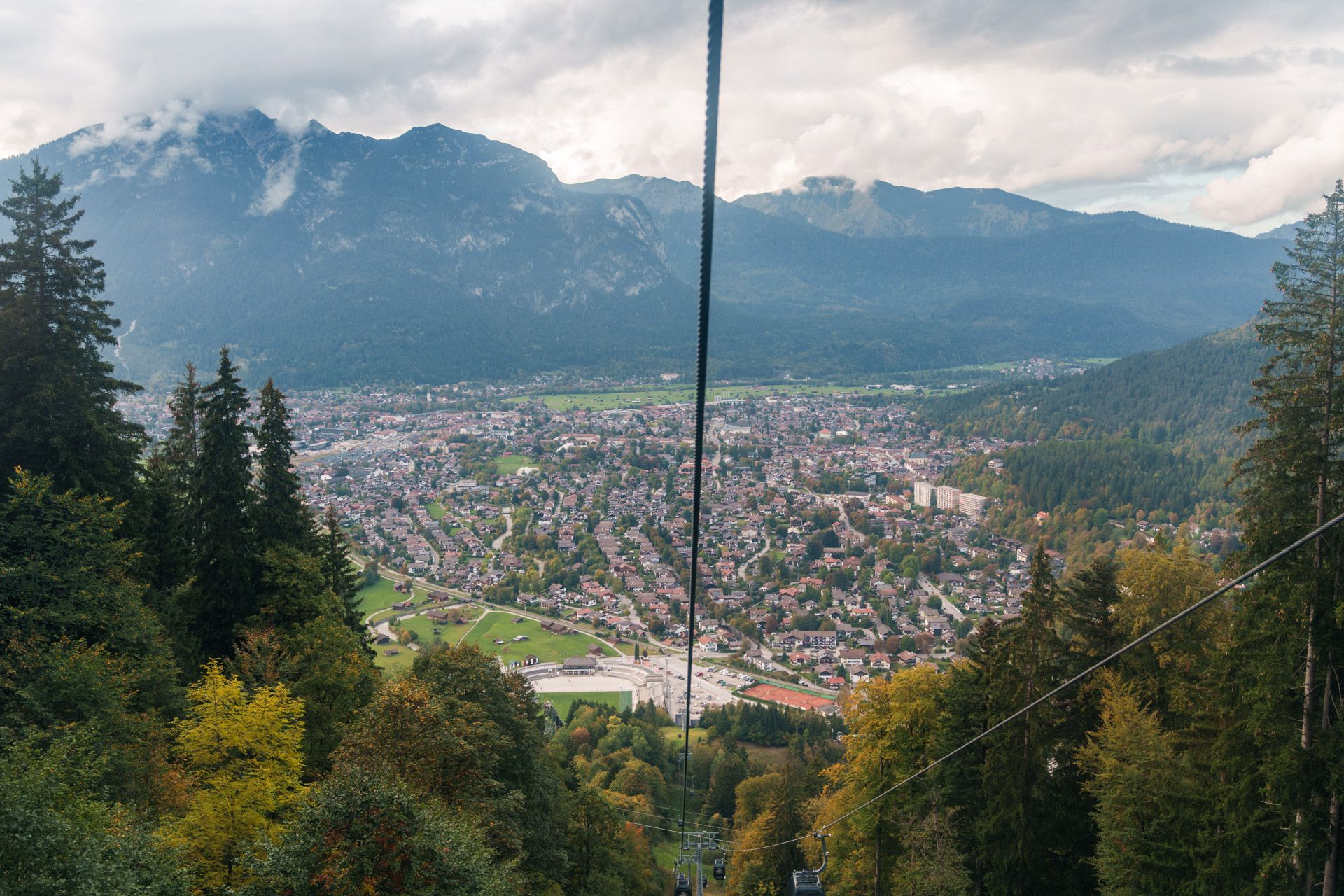 View down the Eckbauerbahn cable towards the Olympic Ski Jump and Garmisch-Partenkirchen