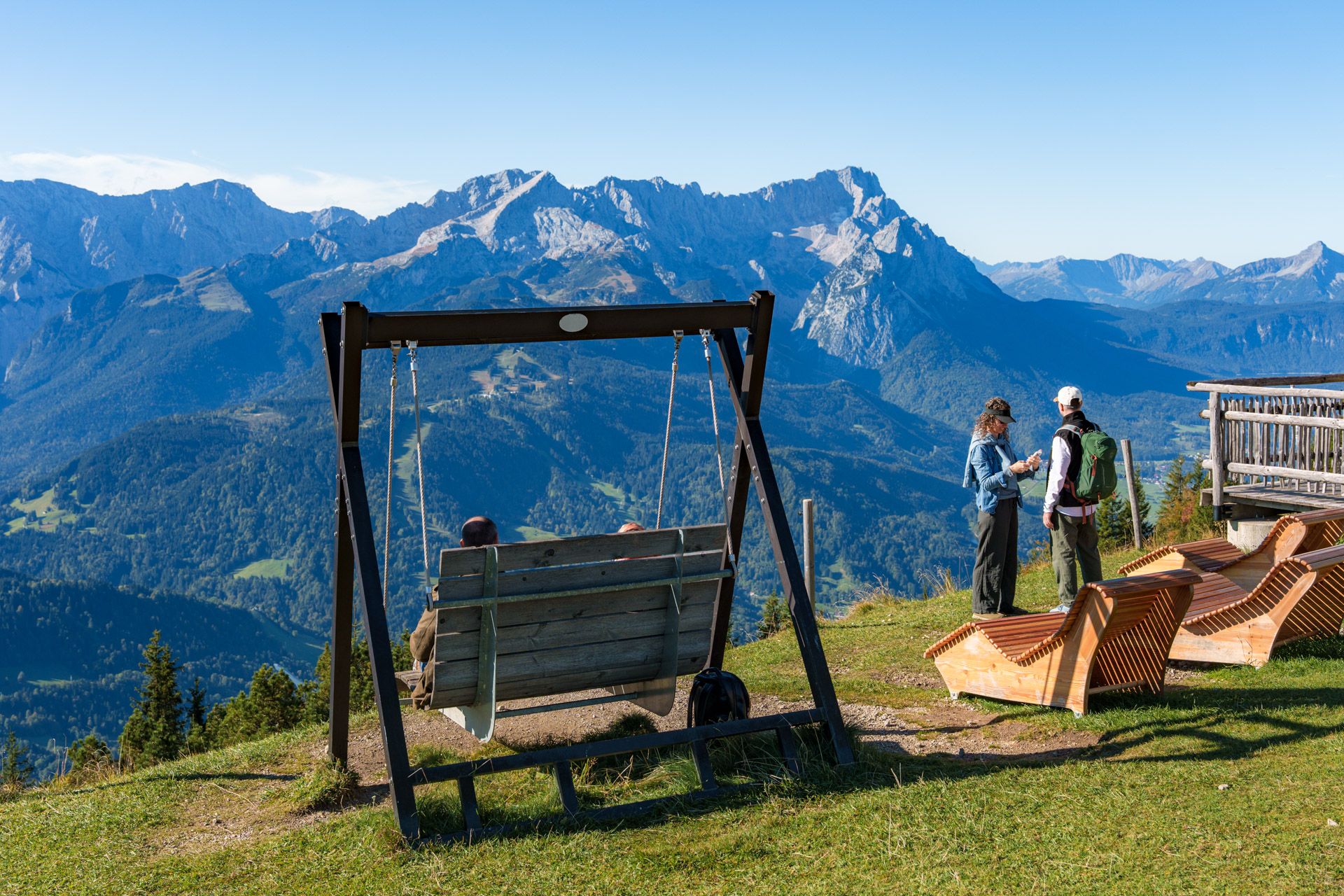 Swing bench and wooden loungers at Wank facing the Wetterstein range