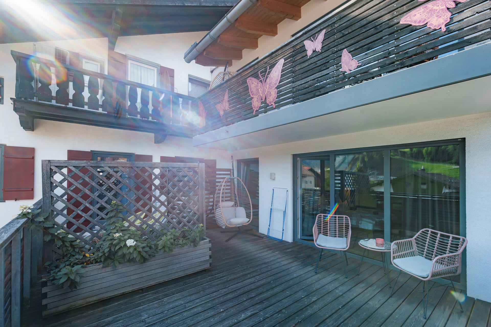 Hanging egg chair on the terrace at Leiners with butterfly decorations