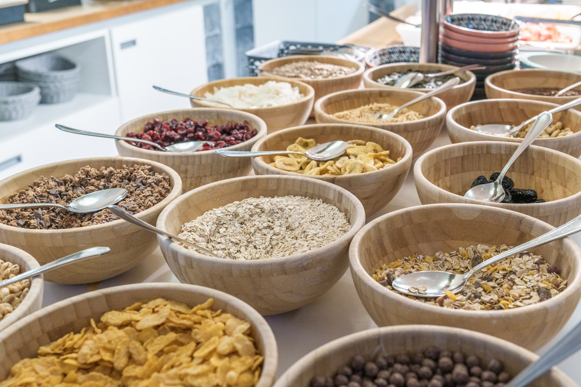 Bowls of cereals, granola and nuts at the breakfast buffet