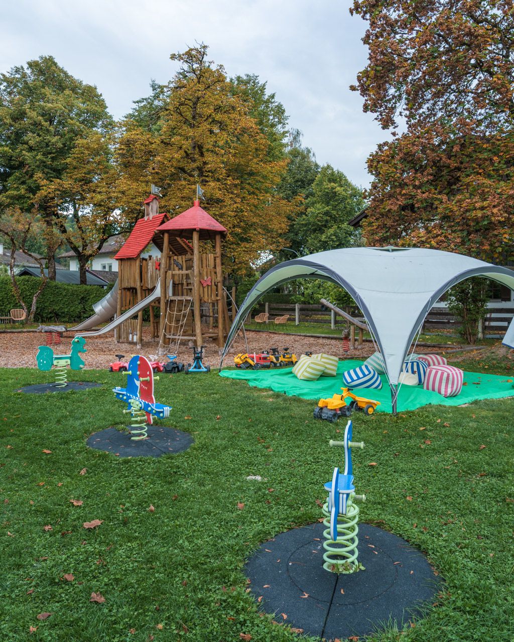 Spring riders and a shaded play tent in the Leiners garden