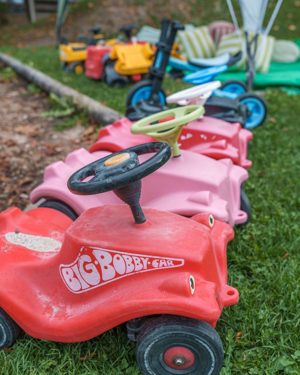 Ride-on toy cars on the grass at Leiners