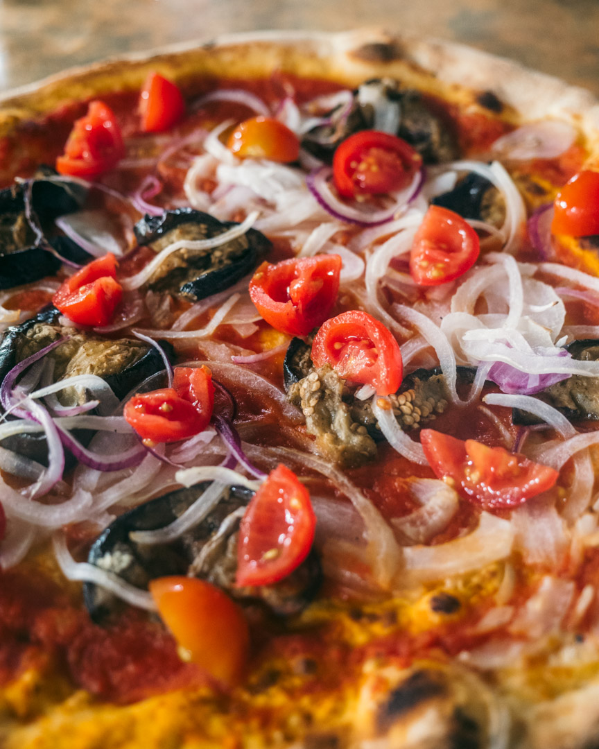 Vegan pizza with eggplant, onion and tomato at La Baita
