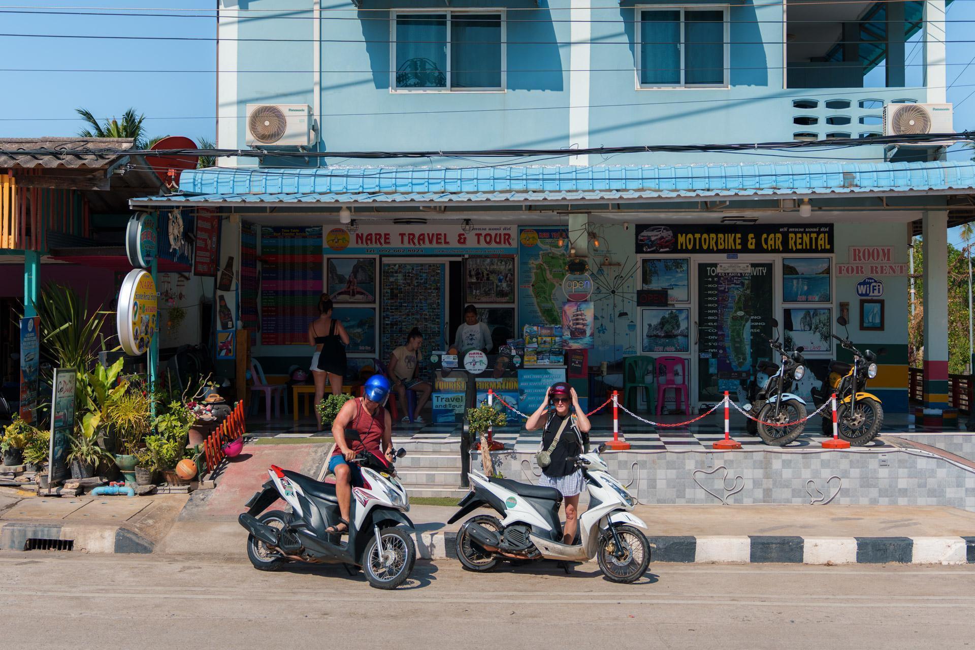 Two people renting scooters in Thailand