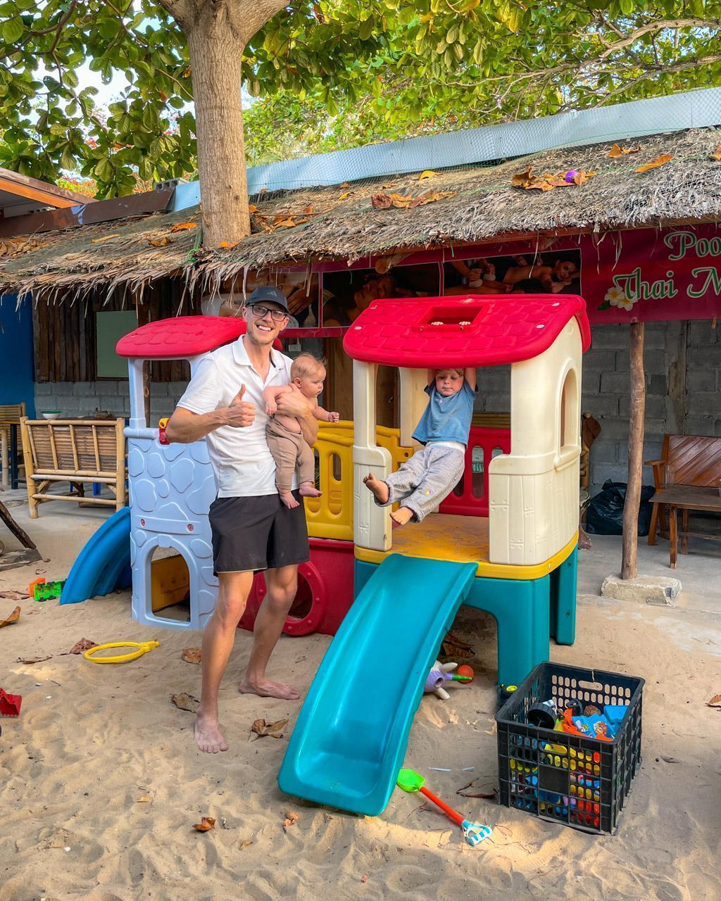 Alex with kids at a restaurant in Koh Lanta