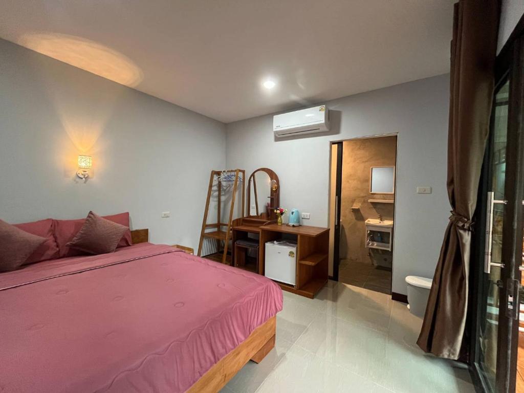 Inside one of the rooms at Kohmook Happy Time Bungalow with a double bed.
