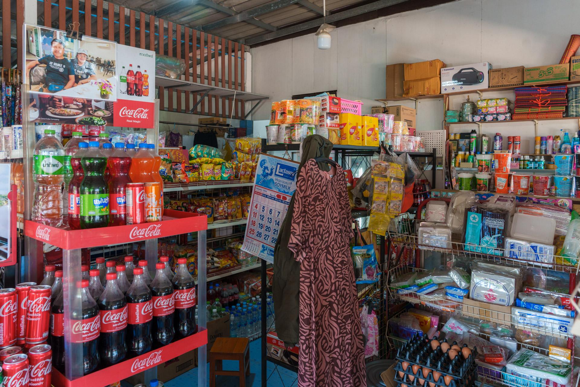 Small convenience store on Koh Mook with Coca-Cola displays and shelves stocked with colourful snacks and drinks.