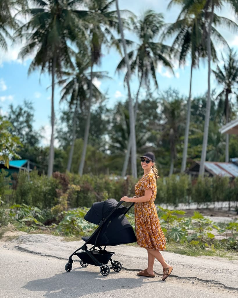 Victoria with Adrian in a stroller in Sri Thanu in Koh Phangan