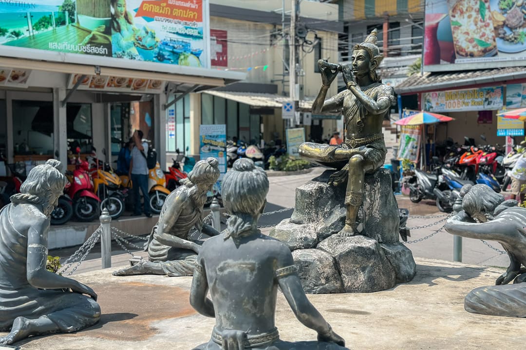 The flute-playing prince statue of Prince Aphai Mani by the harbor