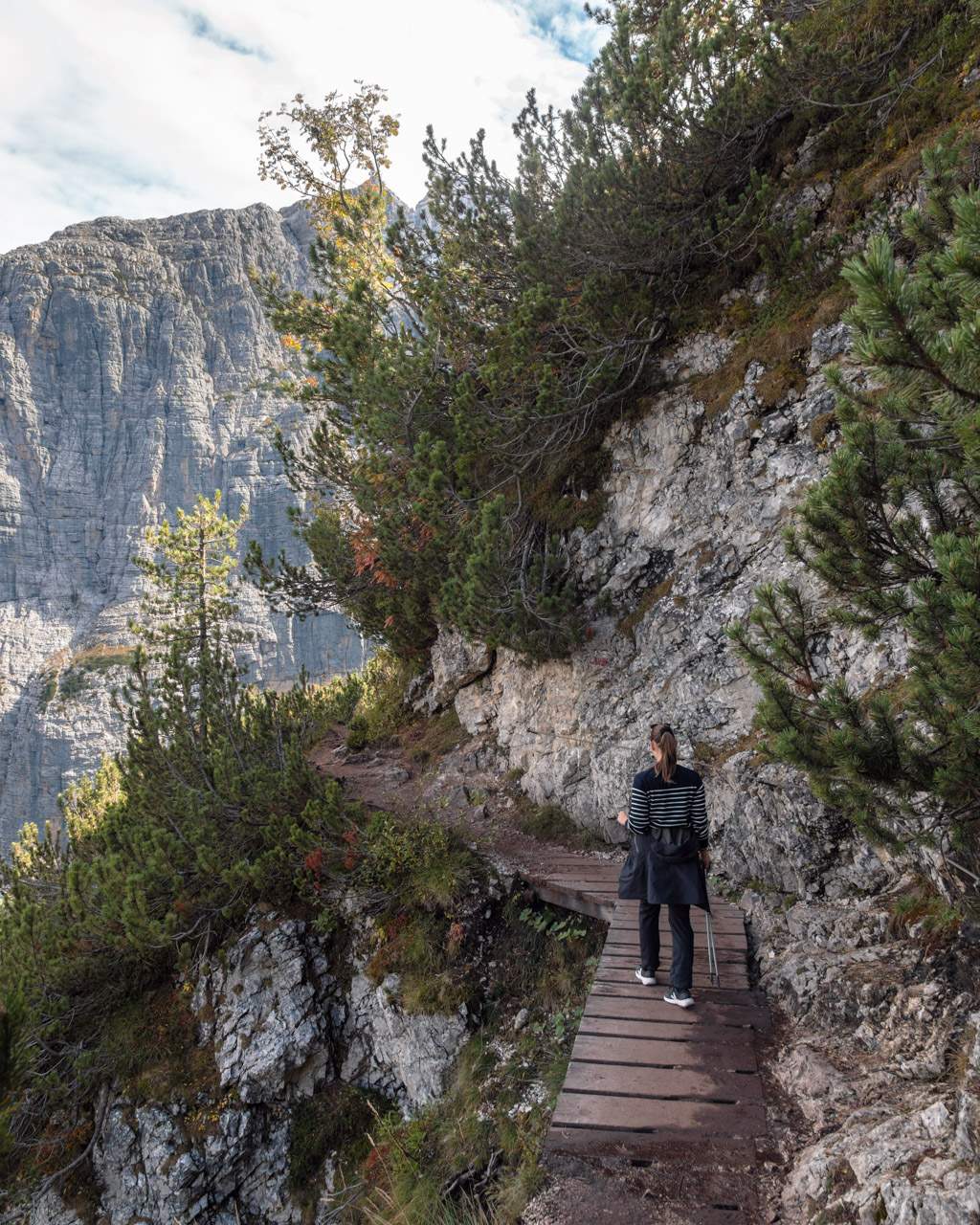 Victoria on a bridge with a steep drop on the way to Lago di Sorapis