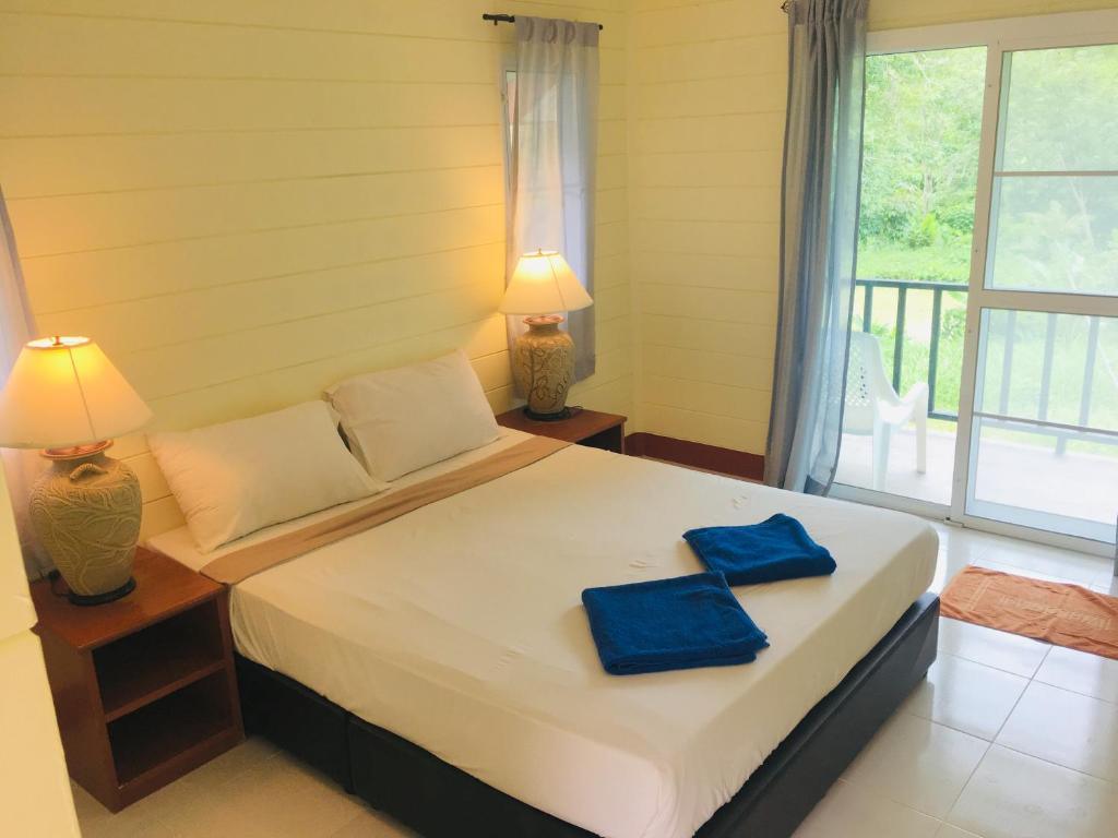 Interior of a bungalow at Mookies with wooden walls and a comfortable bed setup.