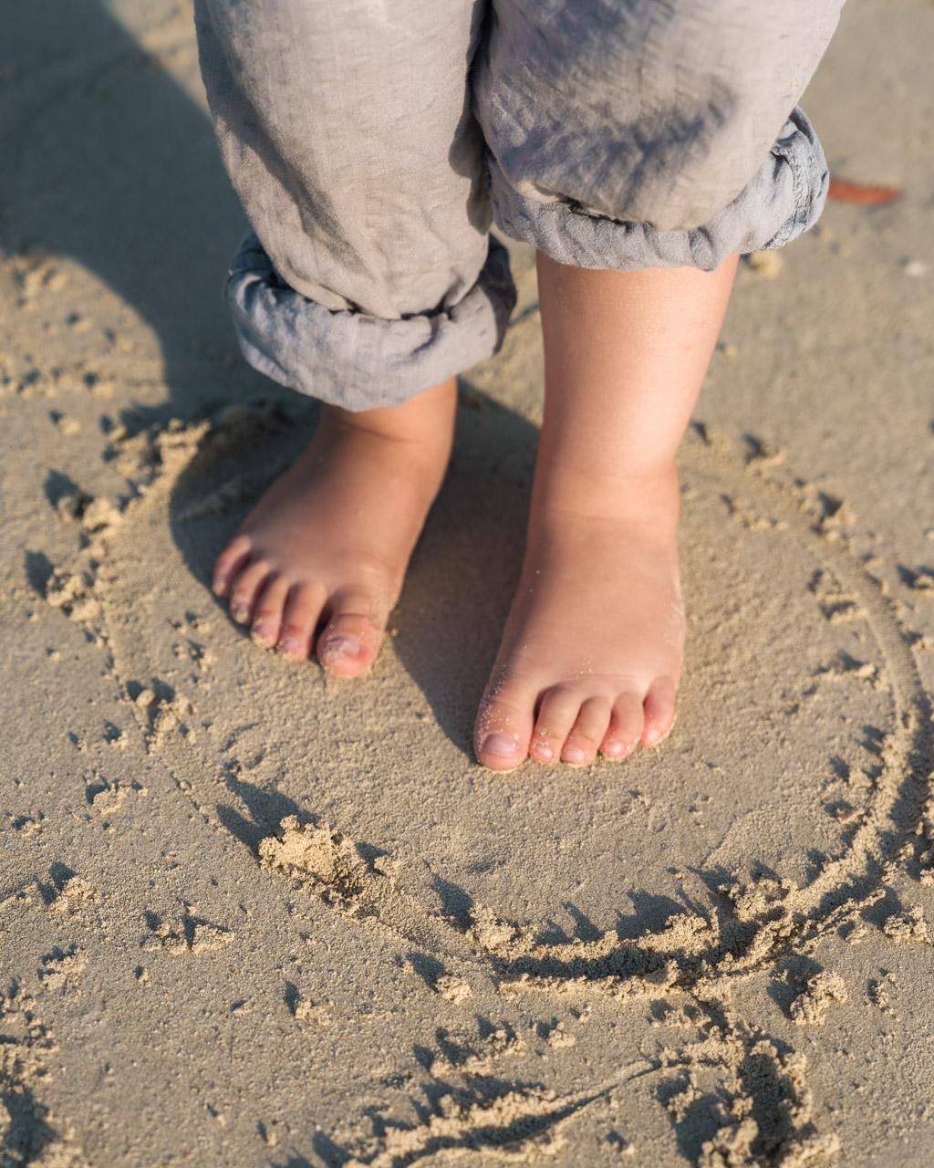 Kid's barefeet in the sand