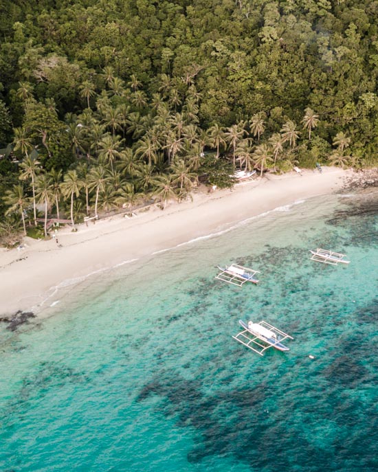 The private beach of Coconut Garden Island Resort on Cacnipa Island