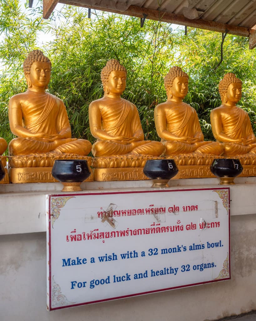 Bowls for alms for the monks with Buddha statues