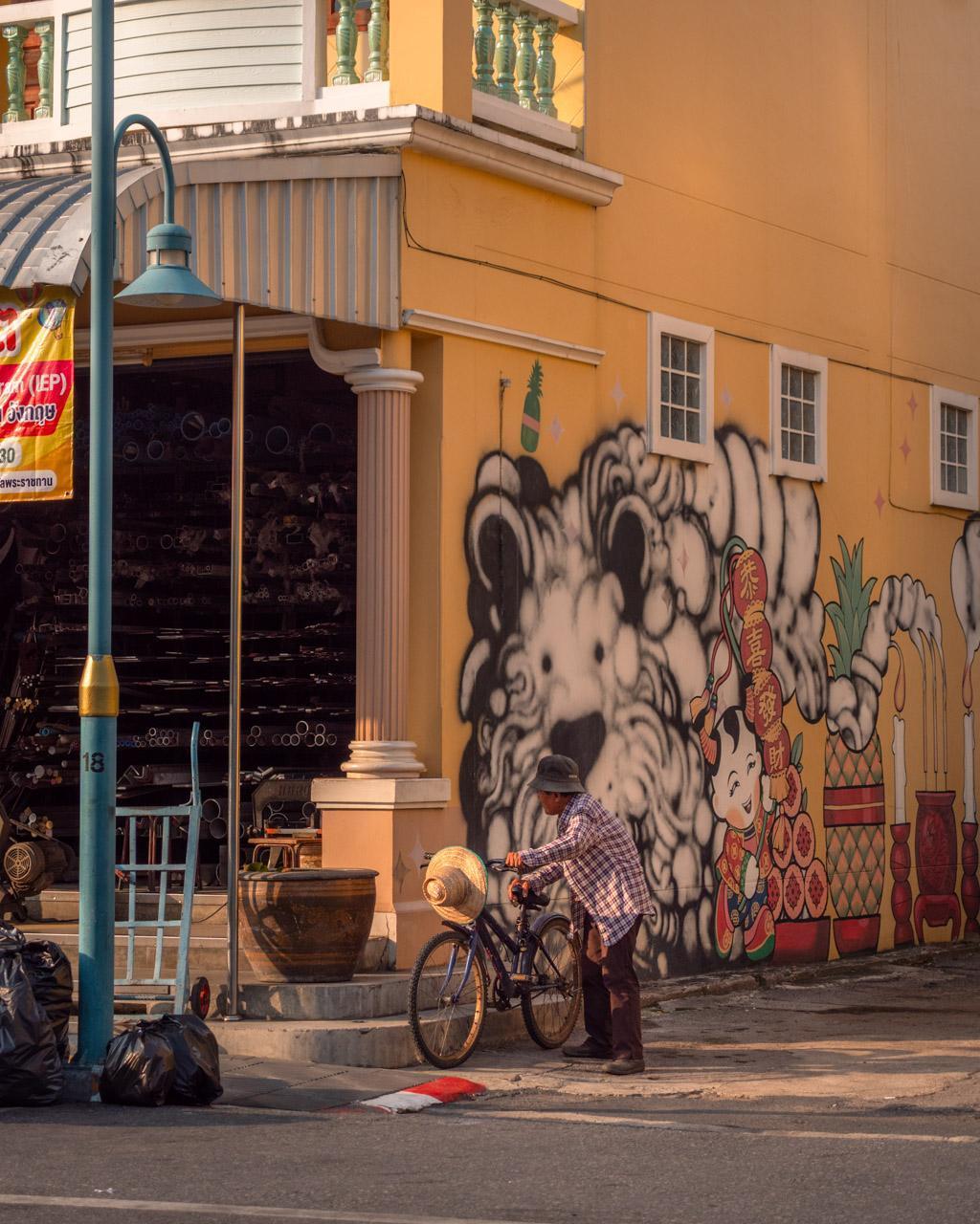 Person on the street in Phuket Old Town with street art