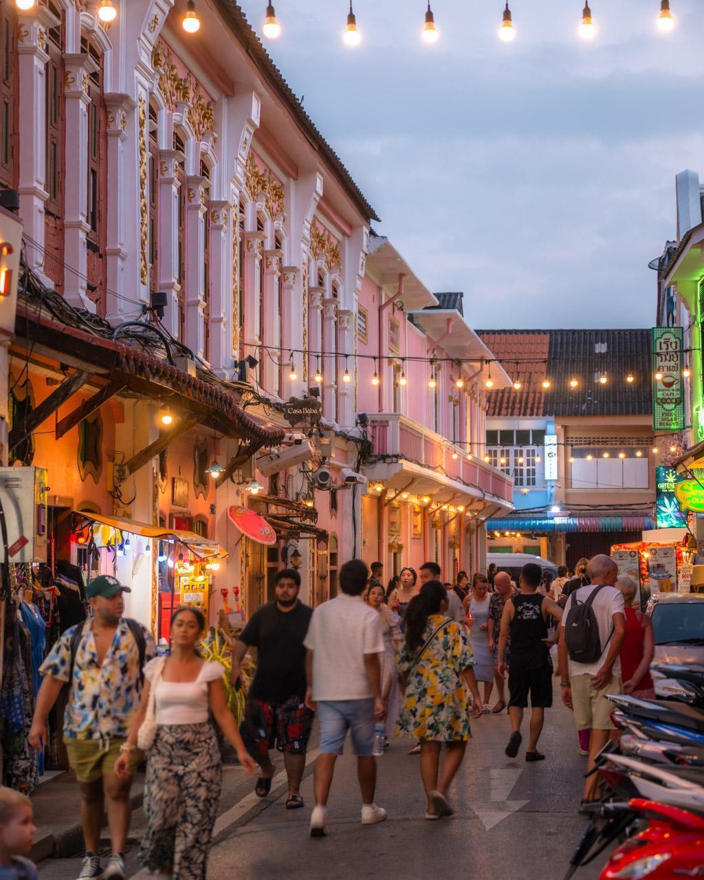 Soi Romanee in the evening light with tourists on the street