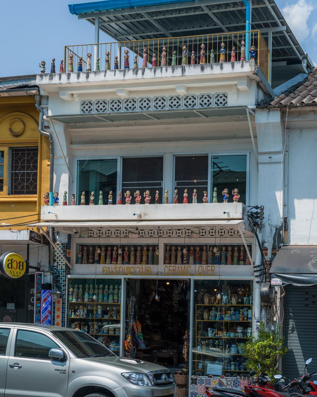 Store front in Old Town with dolls on balconies