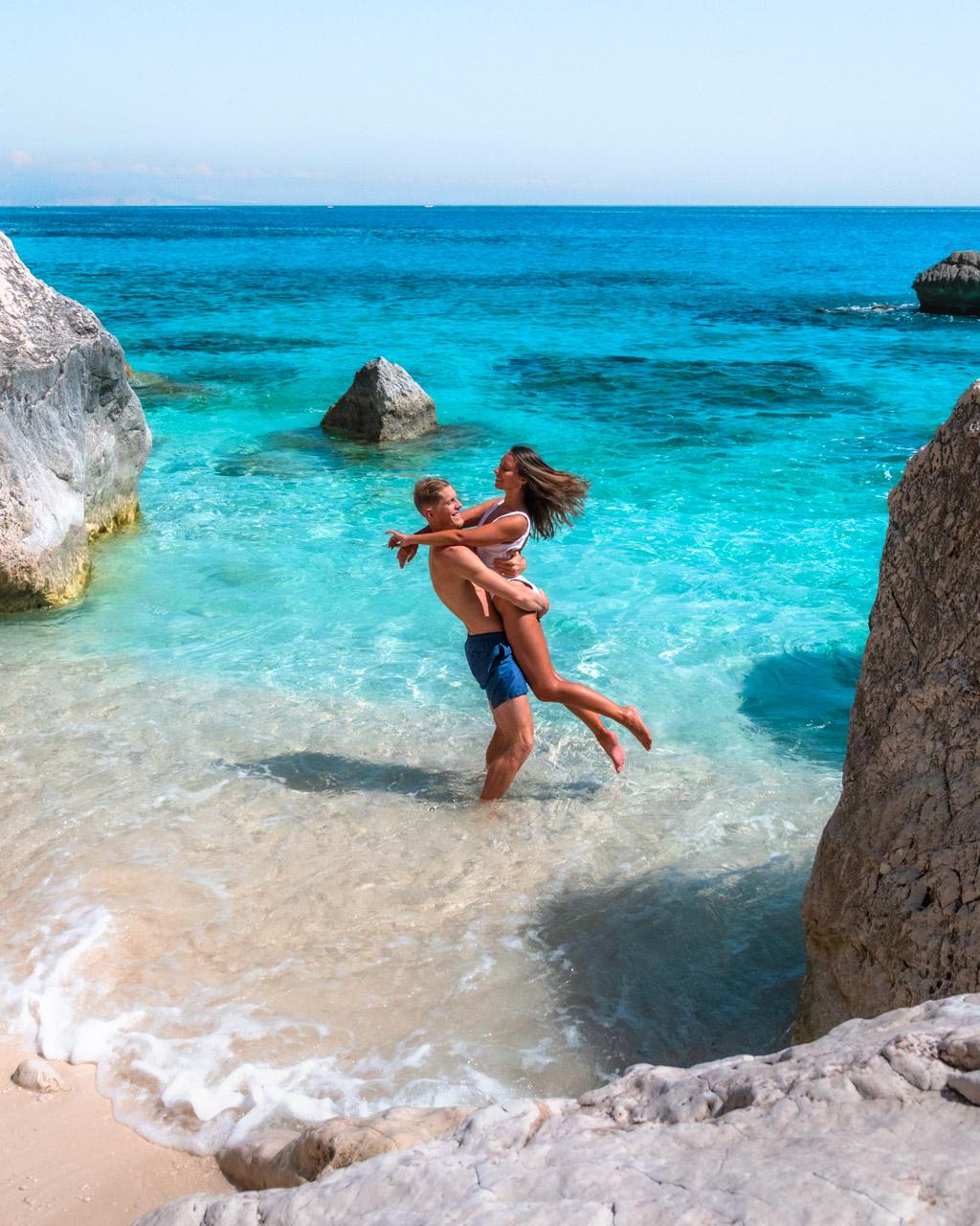 Alex and Victoria in the water on a beautiful beach in Sardinia, Italy