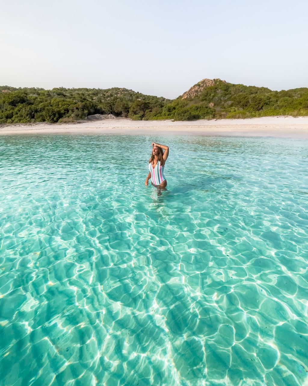 Victoria looking happy in the water by a beach on Sardinia, Italy