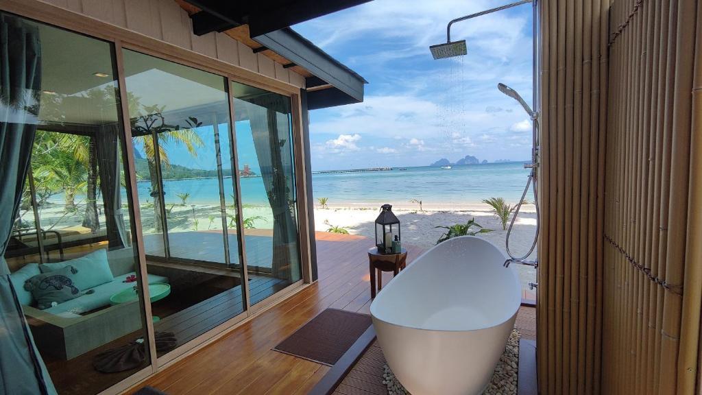 Outdoor bathtub at a Sivalai Beach Resort villa surrounded by tropical greenery.