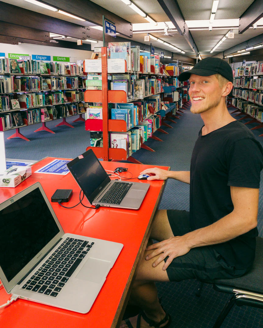 Alex at a public library in New Zealand working