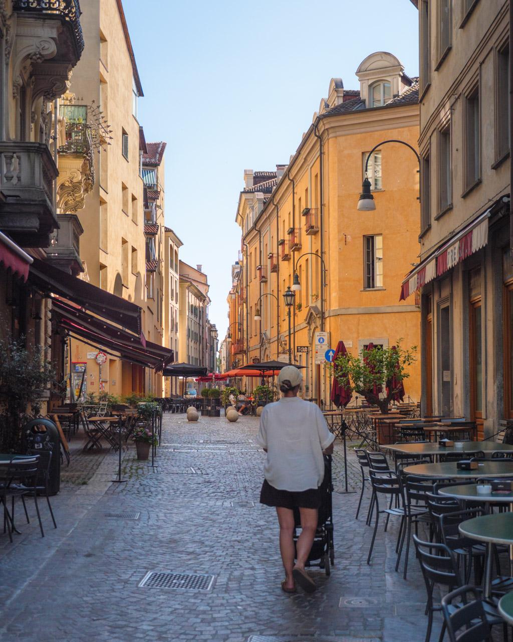 Victoria with a stroller on a quiet street in Torino