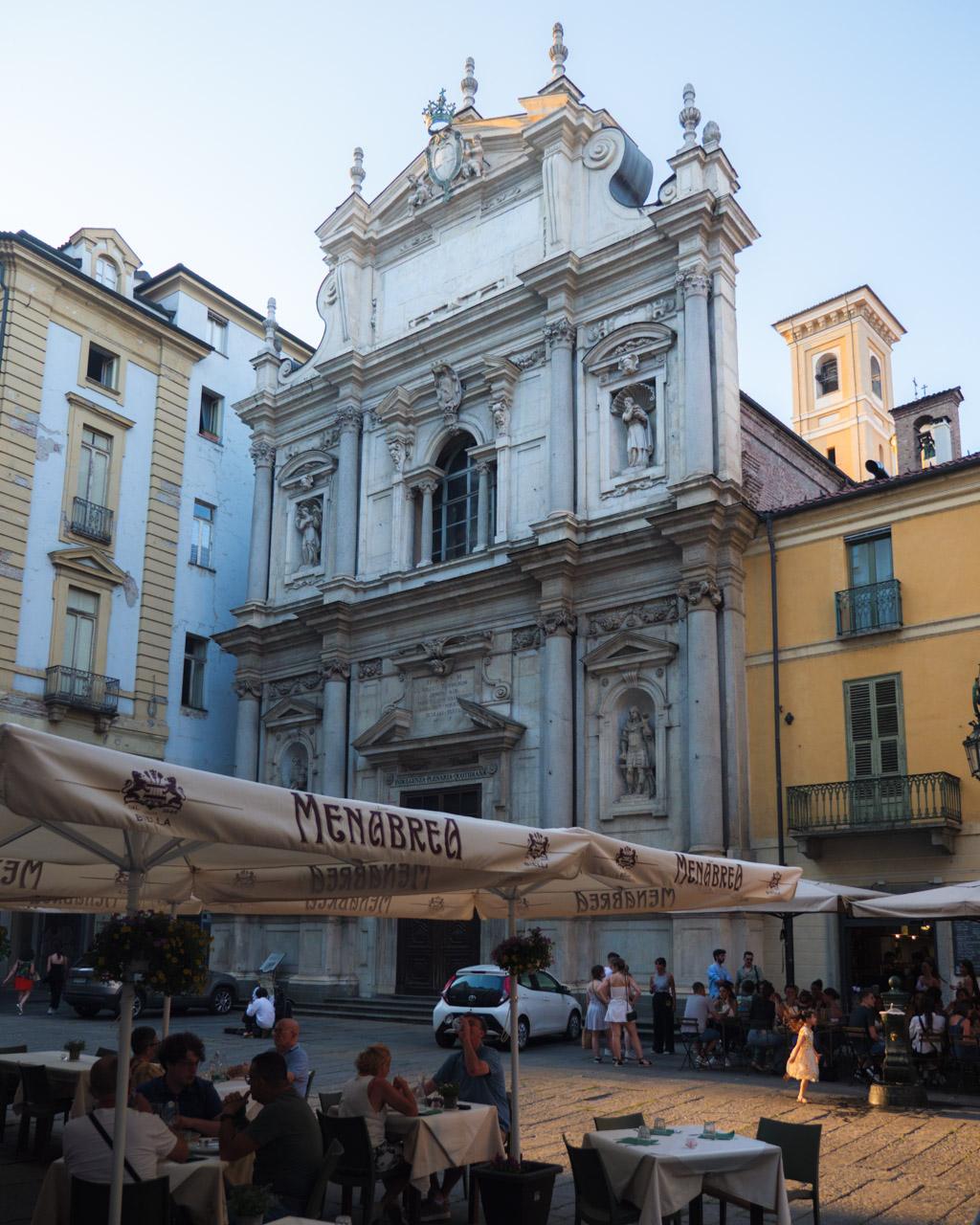 Turin lively place with café and church at dusk in the city centre