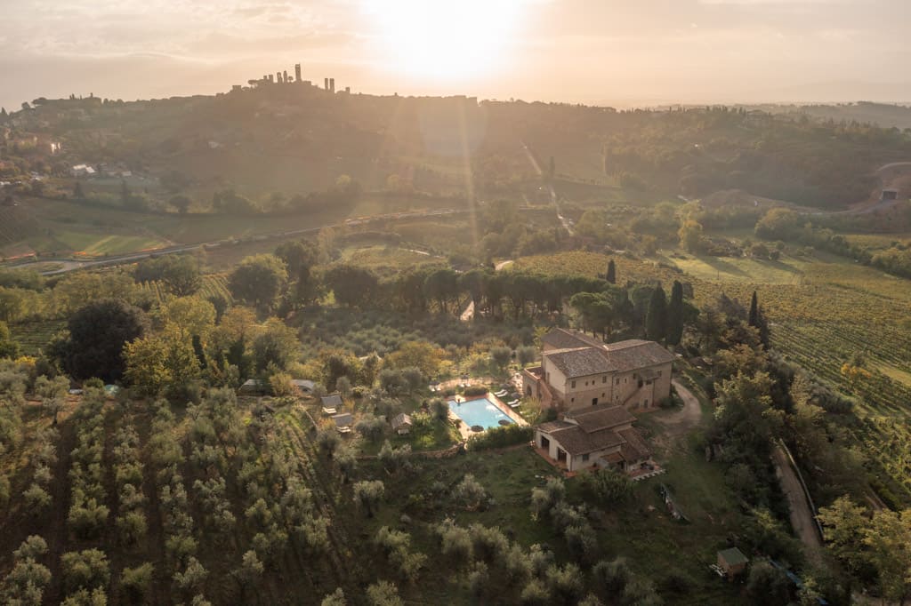 Agrivilla I Pini drone image with San Gimignano on the horizon