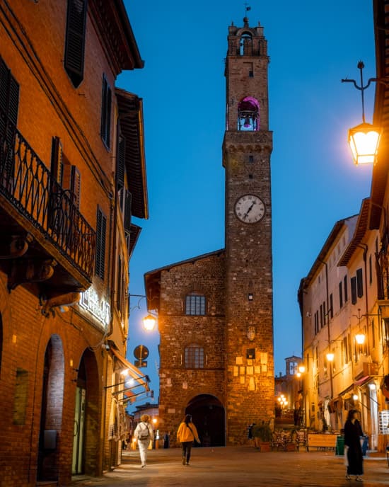 Montalcino at dusk with a tower in a cosy square