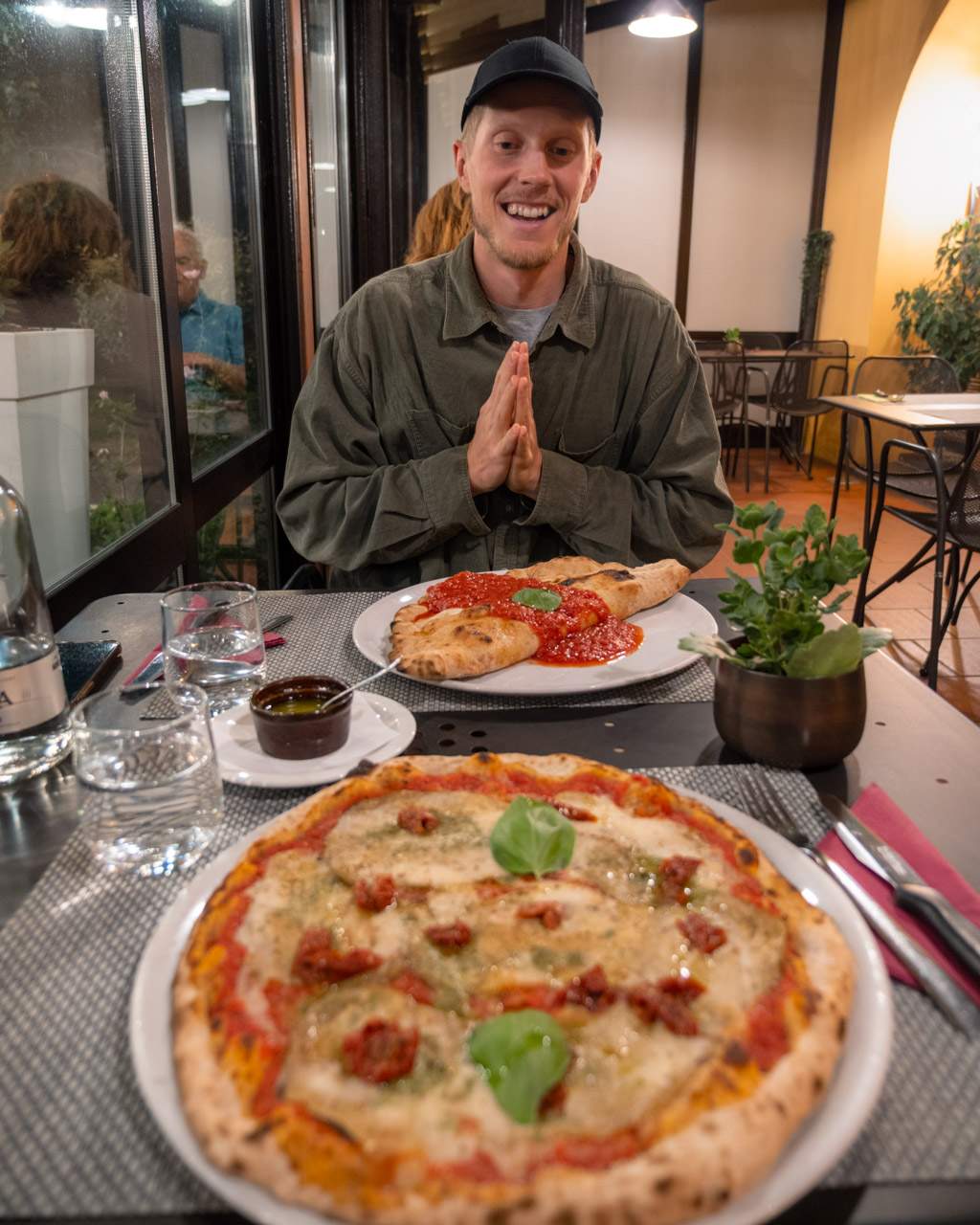 Alex with pizza and calzone at Pizzeria Paradiso