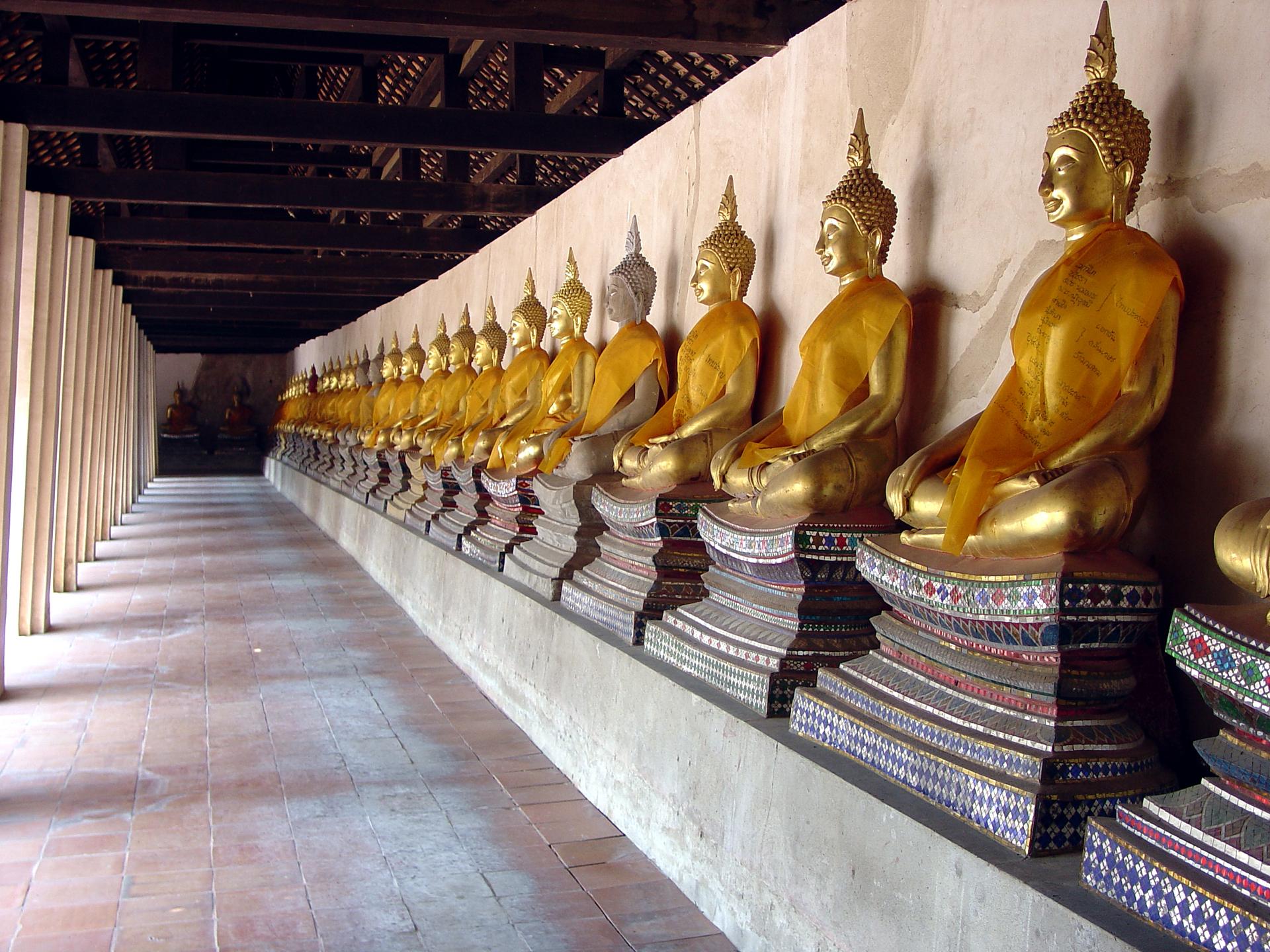 Long row of golden Buddha statues at Wat Phutthaisawan